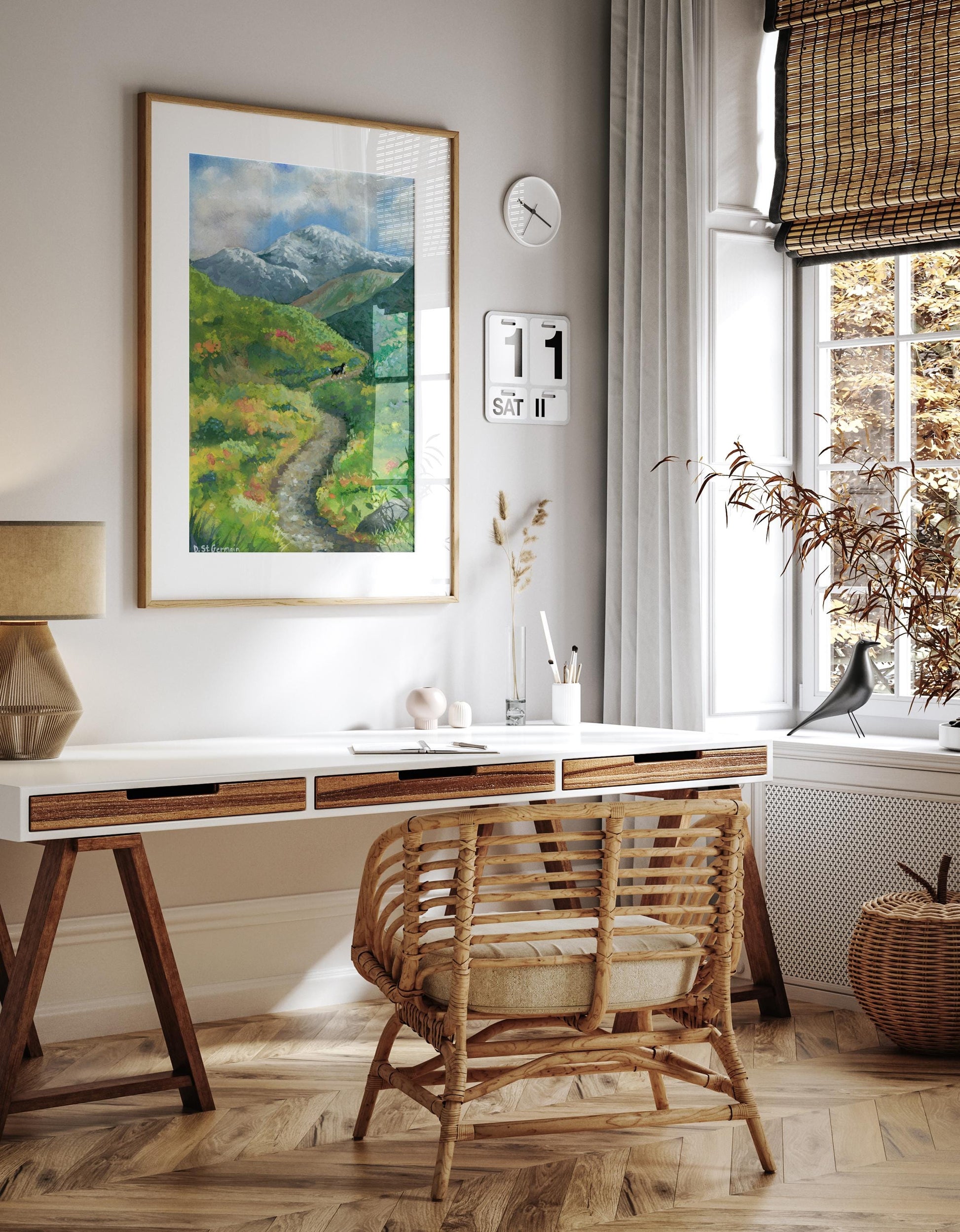 Framed colorful gouache landscape of Bernese Mountain Dog hiking on a trail in the Alaskan Mountains hanging above a desk in a neutral colored office.