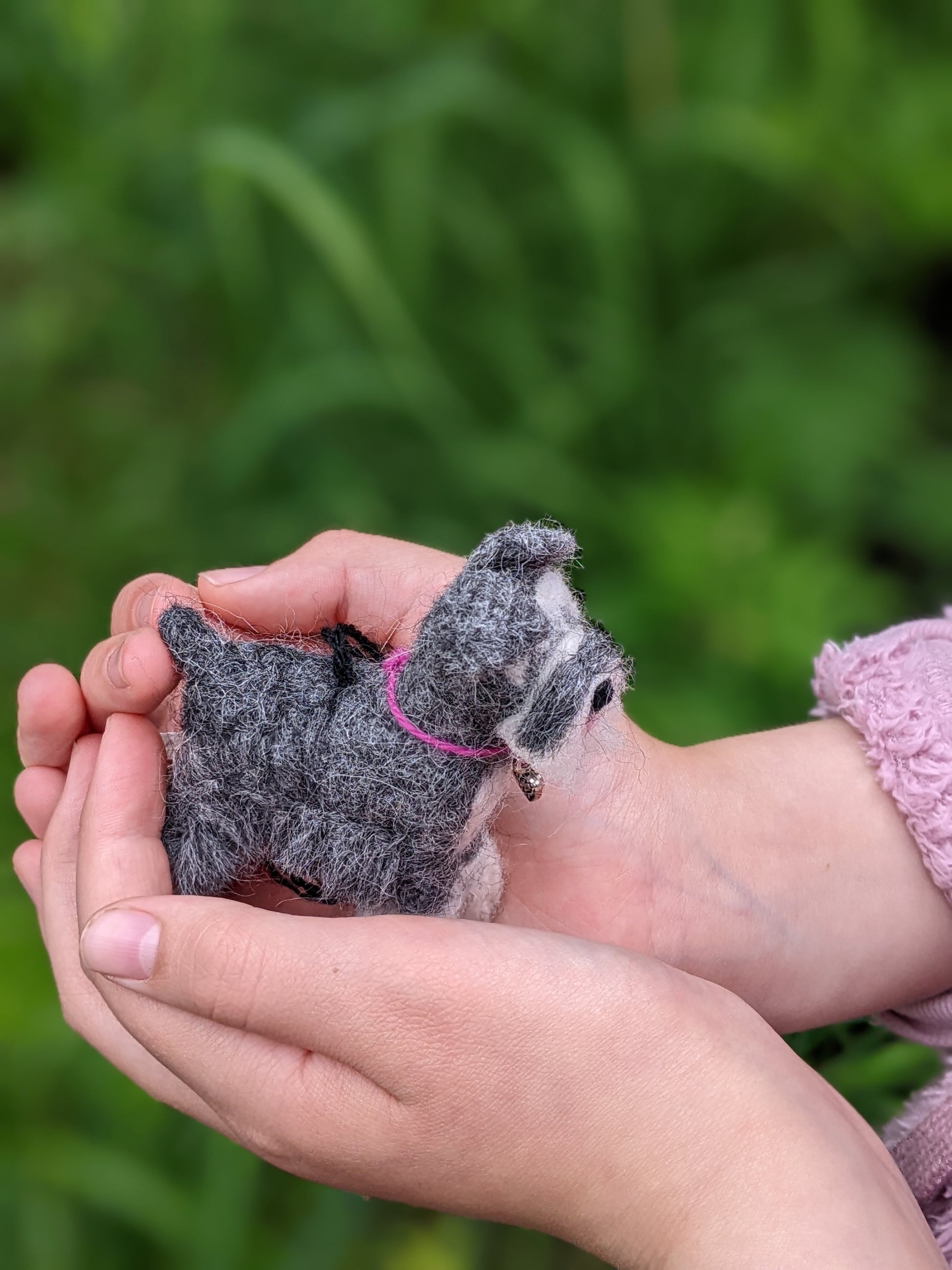 little gray schnauzer needle felted from alpaca wool held in child's hands