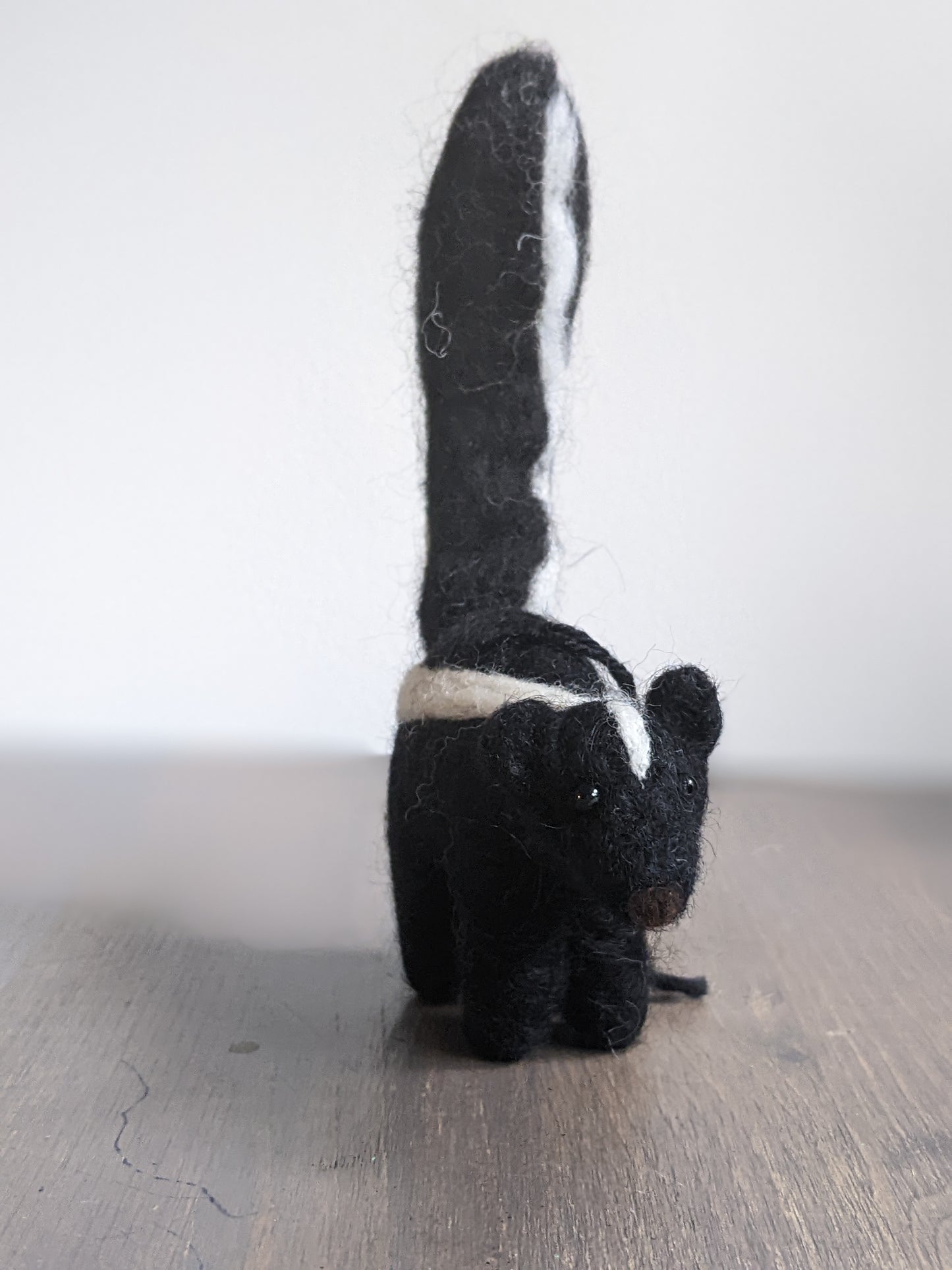 black and white needle felted wool skunk ornament
