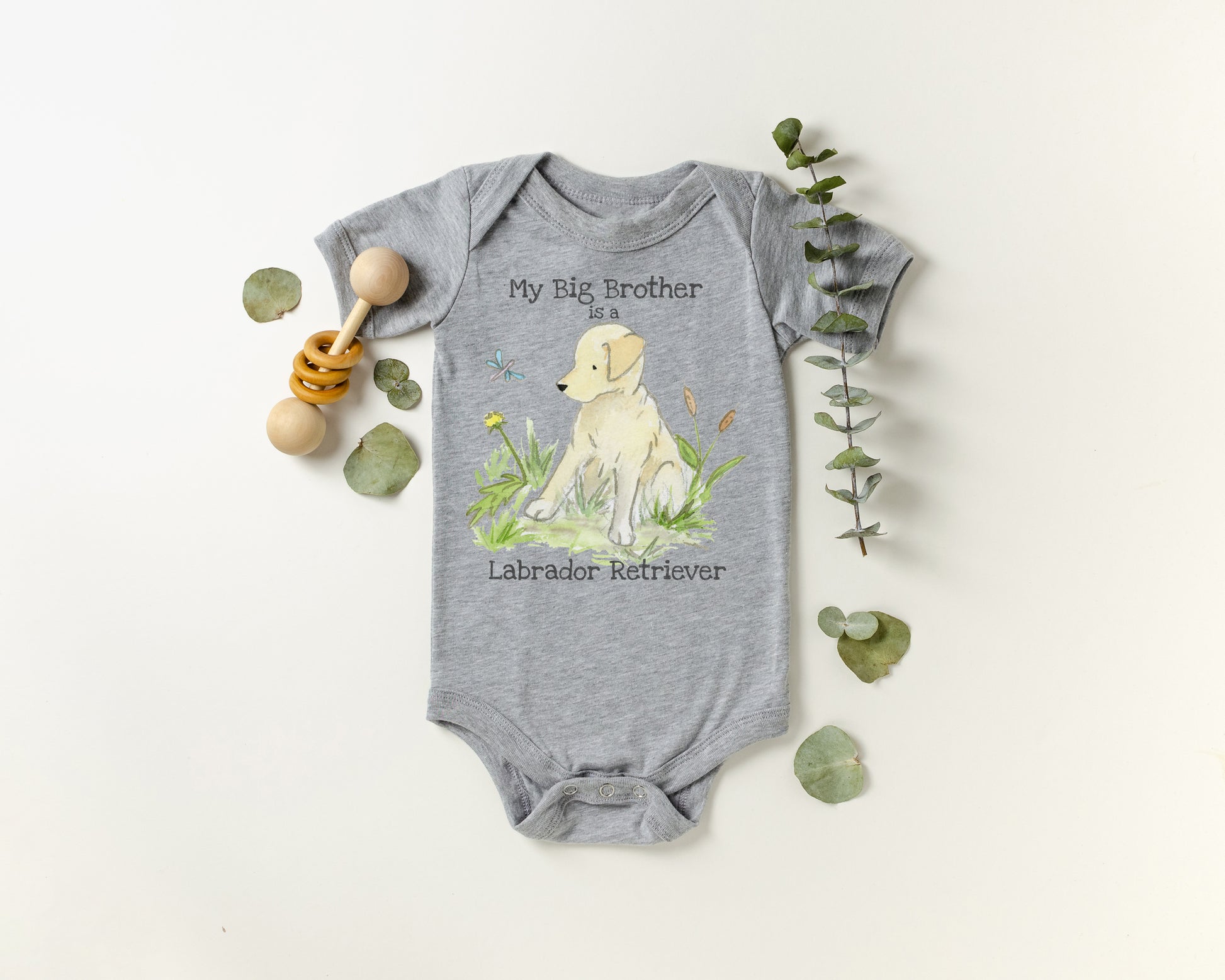 Gray baby onesie with Labrador Retriever design and text on a white background