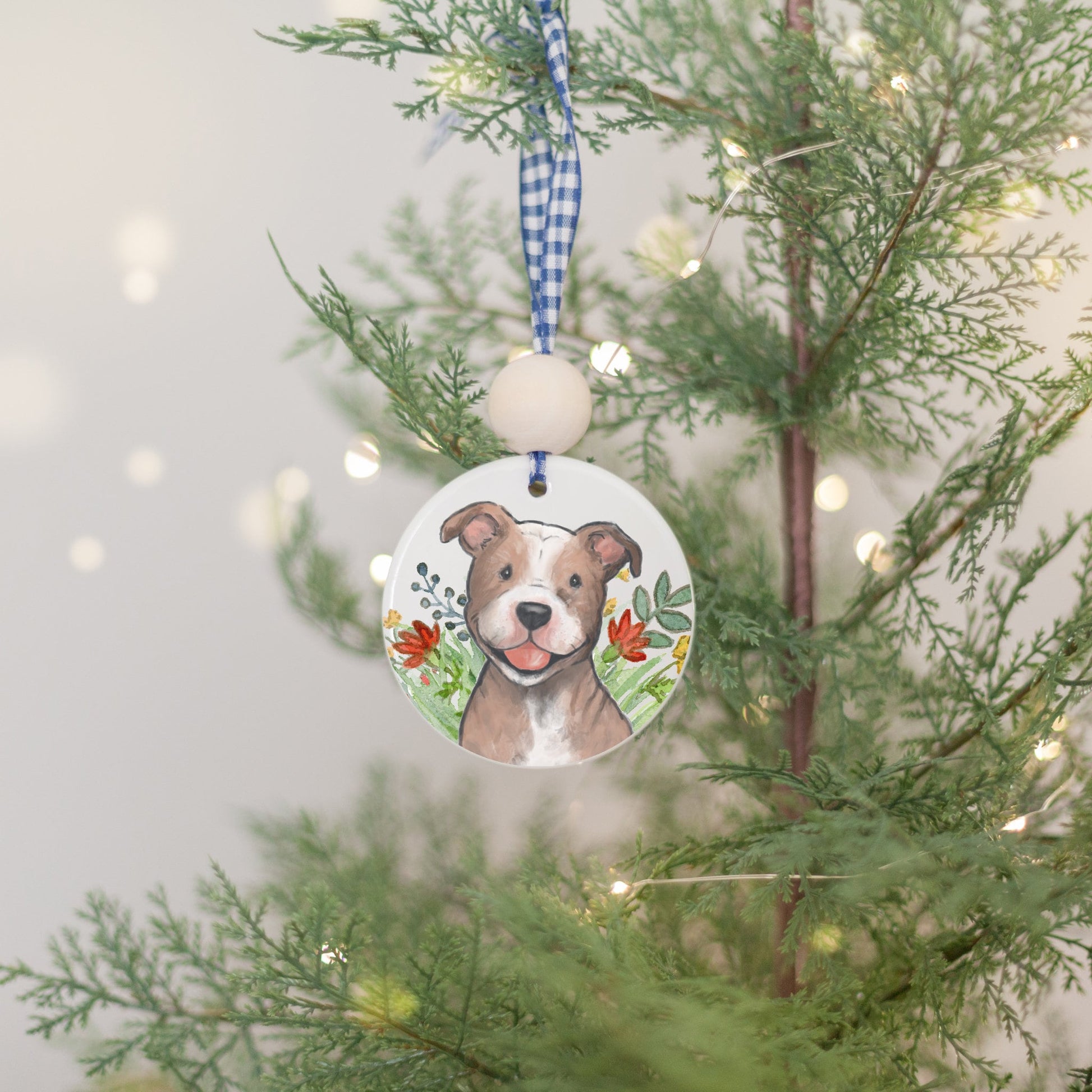 Ceramic ornament with painting of a happy brown and white pitbull dog and colorful flowers