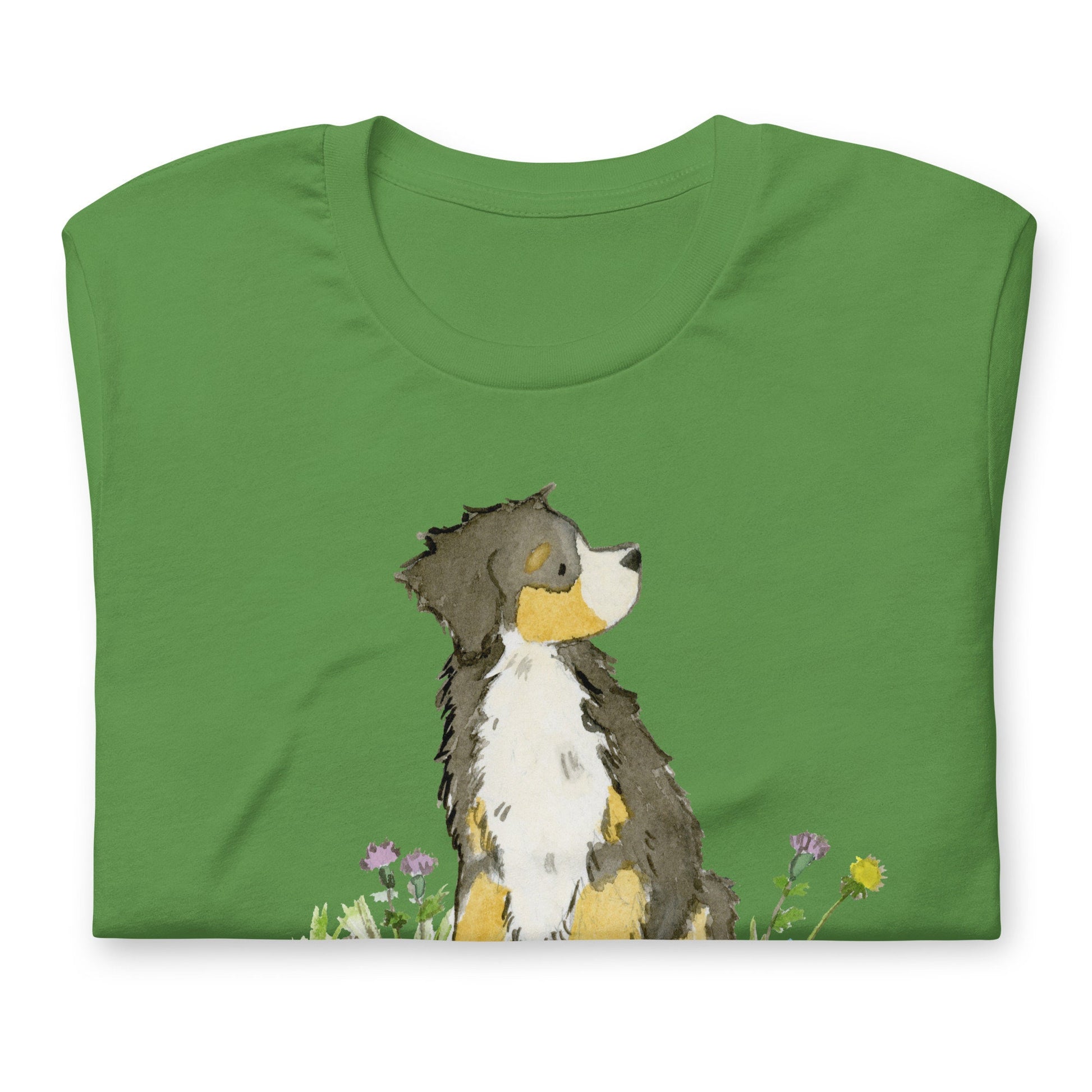 Folded green tee with cute Bernese mountain dog artwork on it.