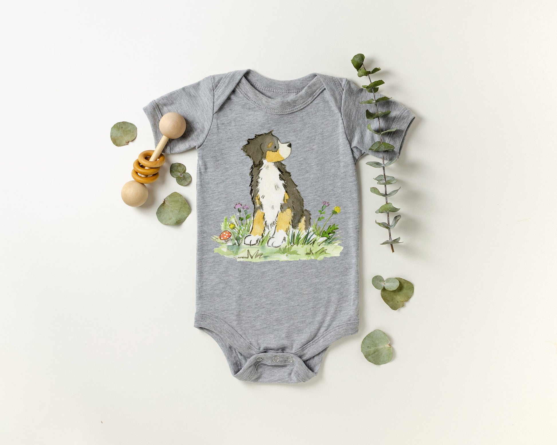 Grey colored infant bodysuit with artwork of a cute Bernese Mountain Dog on it.