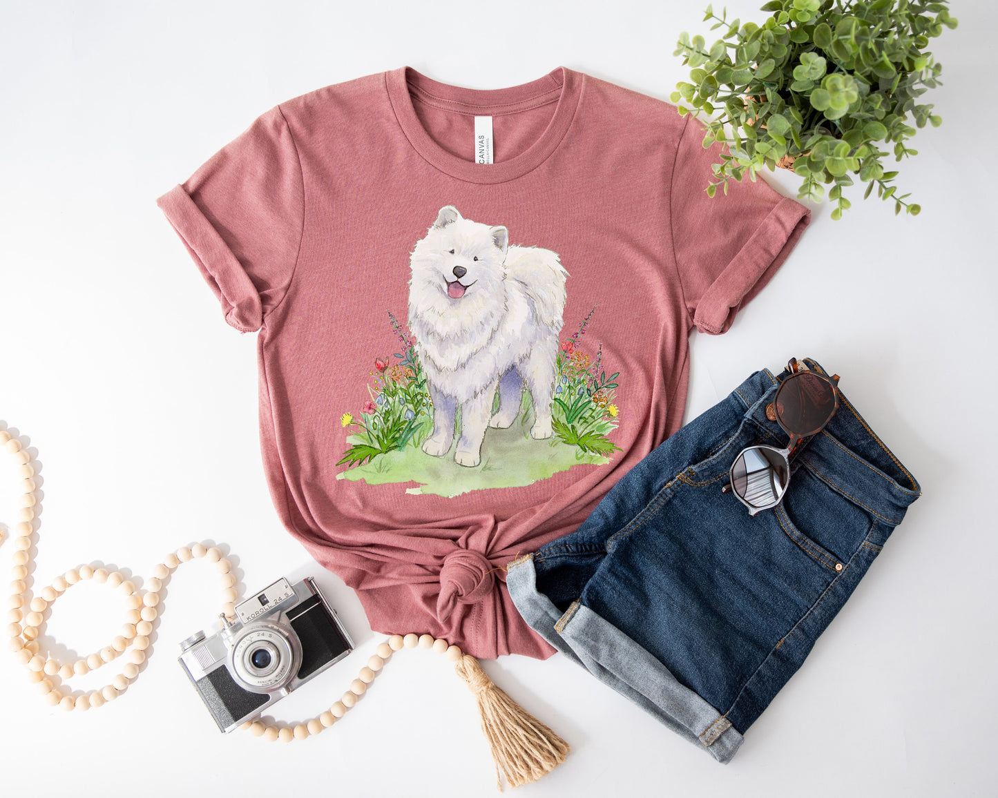 Mauve t-shirt with cute, fluffy, white samoyed dog and colorful flowers on it.