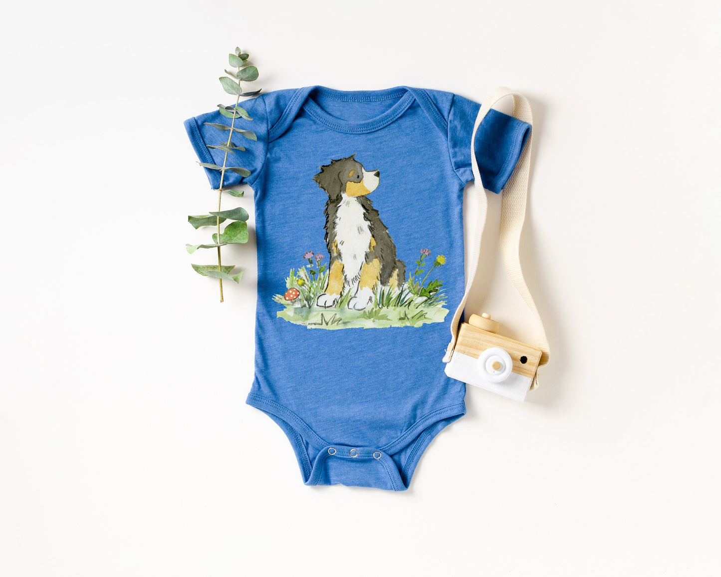 Blue colored infant bodysuit with artwork of a cute Bernese Mountain Dog on it.