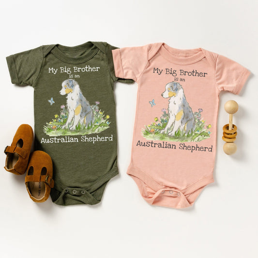 Olive and peach baby bodysuits with a cute blue merle australian shepherd and the words &quot;my big brother is an australian shepherd&quot; on them.