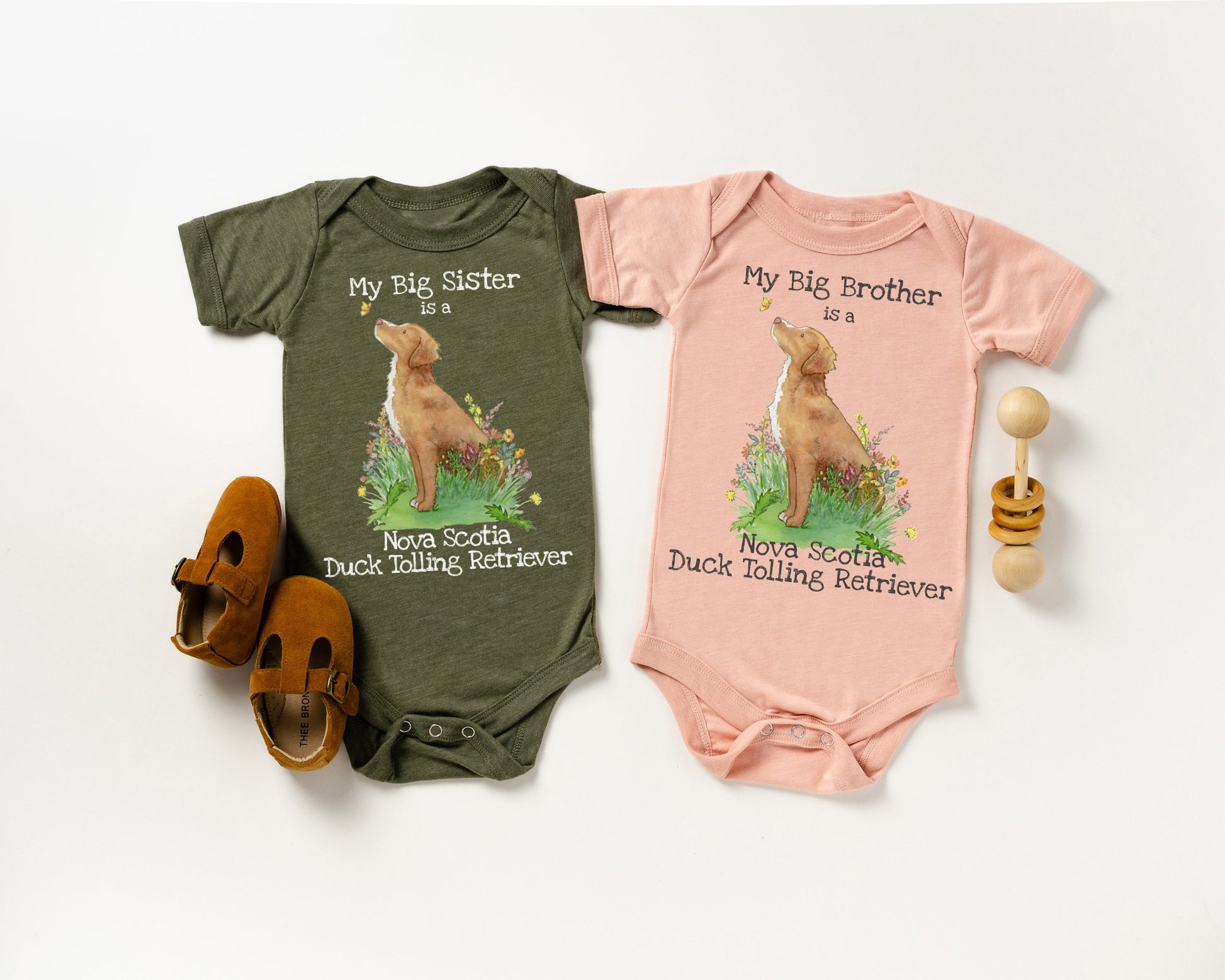 Baby one-piece bodysuit with cute artwork of a Nova Scotia Duck Tolling Retriever looking at a butterfly and the words, &quot;My big brother is a Nova Scotia Duck Tolling Retriever&quot; on it.