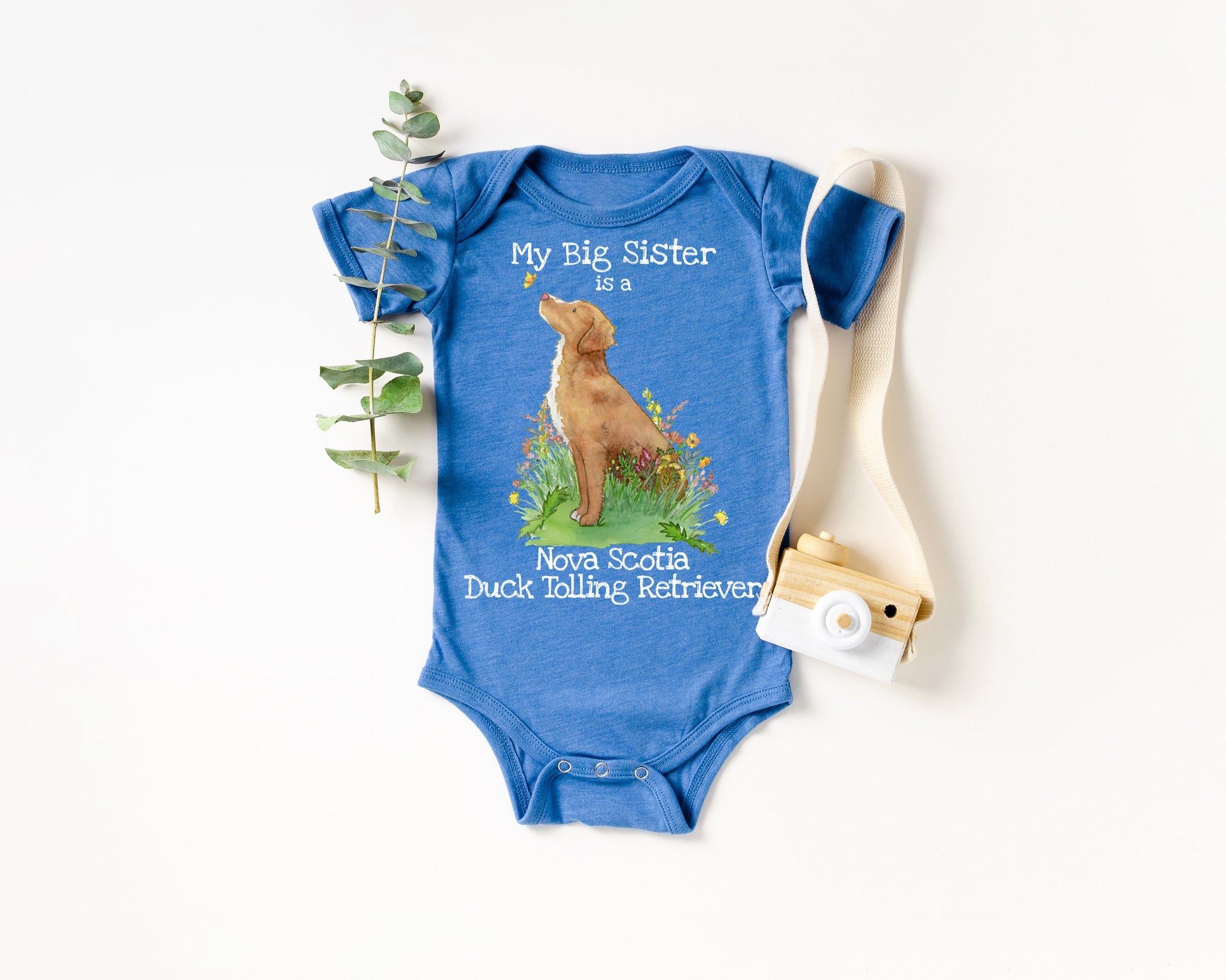 Baby one-piece bodysuit with cute artwork of a Nova Scotia Duck Tolling Retriever looking at a butterfly on it.